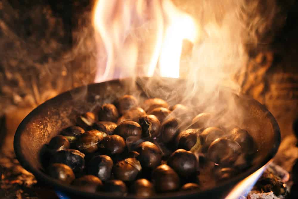 Chestnuts roasted in the chimney and smoking.Celebrating the "Castanyada, Castañada" a typical dish and tradition of Catalonia, Spain, on All Saints Day.