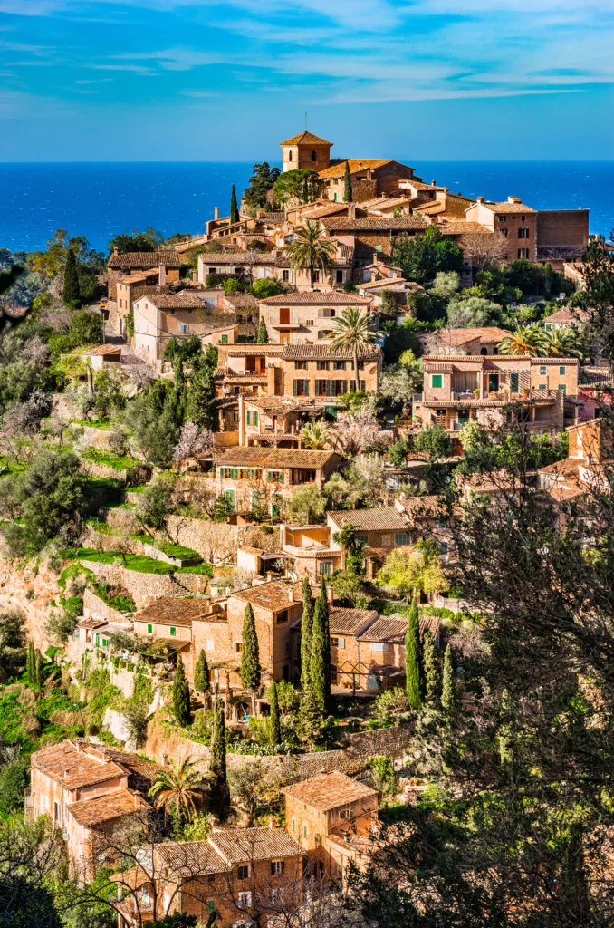 Rustic Mediterranean village nestled in Majorca's mountains overlooking the sea, Spain.