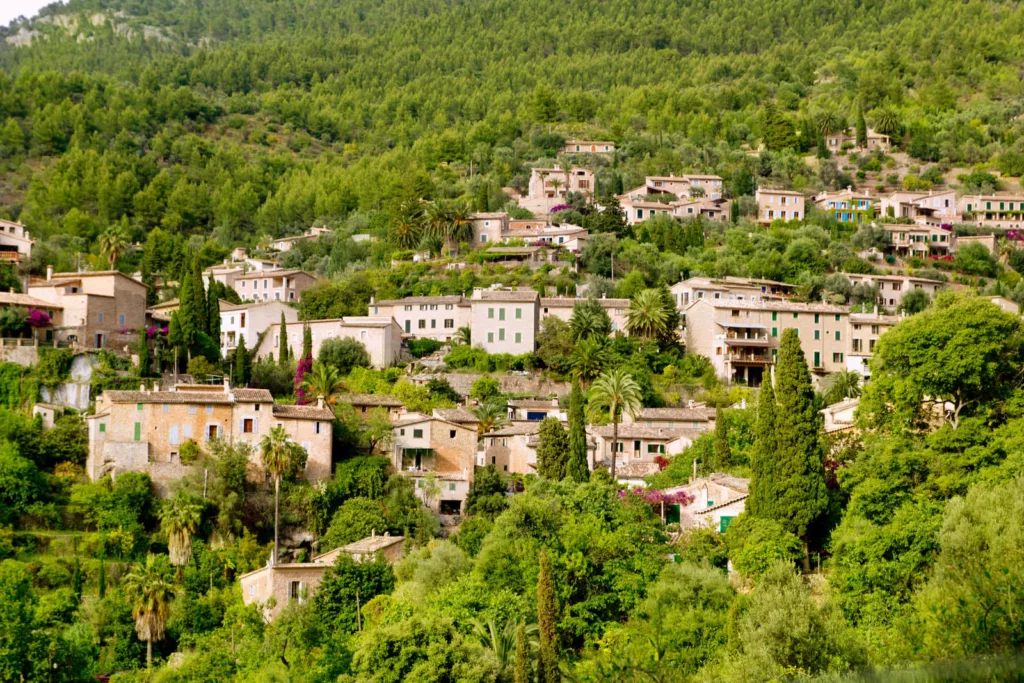 A picturesque view of Deià village nestled in the Tramuntana Mountain range in Majorca, Spain