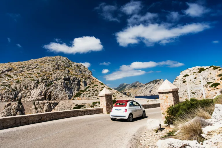 Small European car navigating winding road in Mallorca, Spain