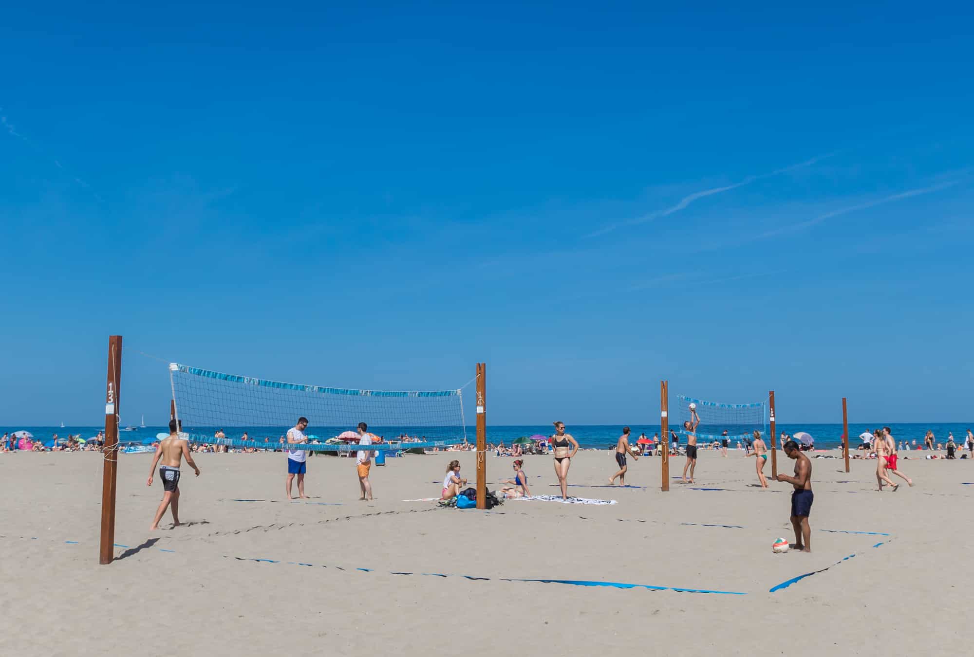 People playing volleyball on the beach of Valencia, Spain