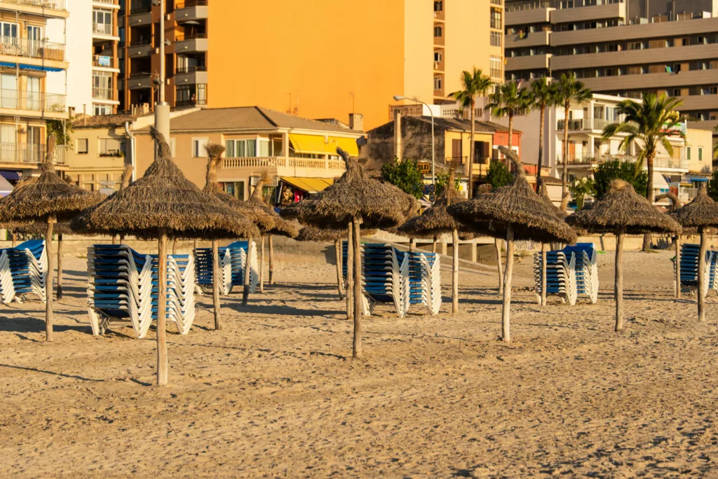 Beach with umbrellas and benches