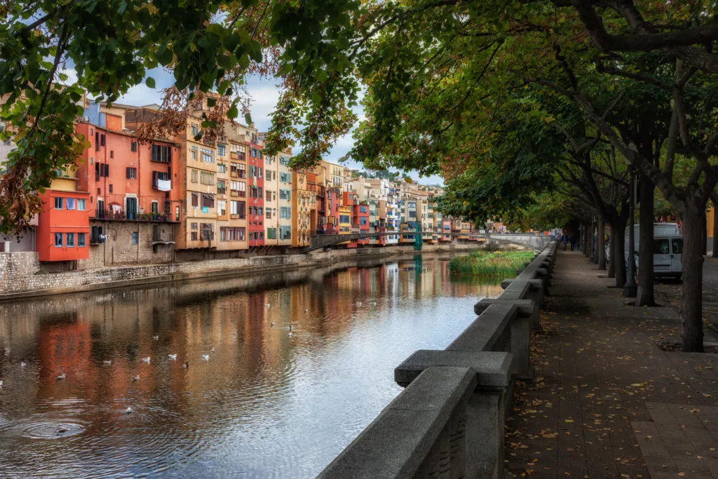Alley lined with trees along Onyar River at Old Quarter (Barri Vell) of Girona city in Catalonia