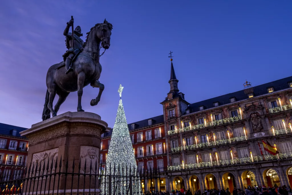 Madrid, bronze statue of King Philip III and illuminated christmas tree in Plaza Mayor.