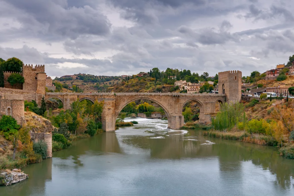 Alcantara Bridge or Puente de Alcntara . Stone arch bridge in the city Toledo. Spain. Castilla la Mancha.
