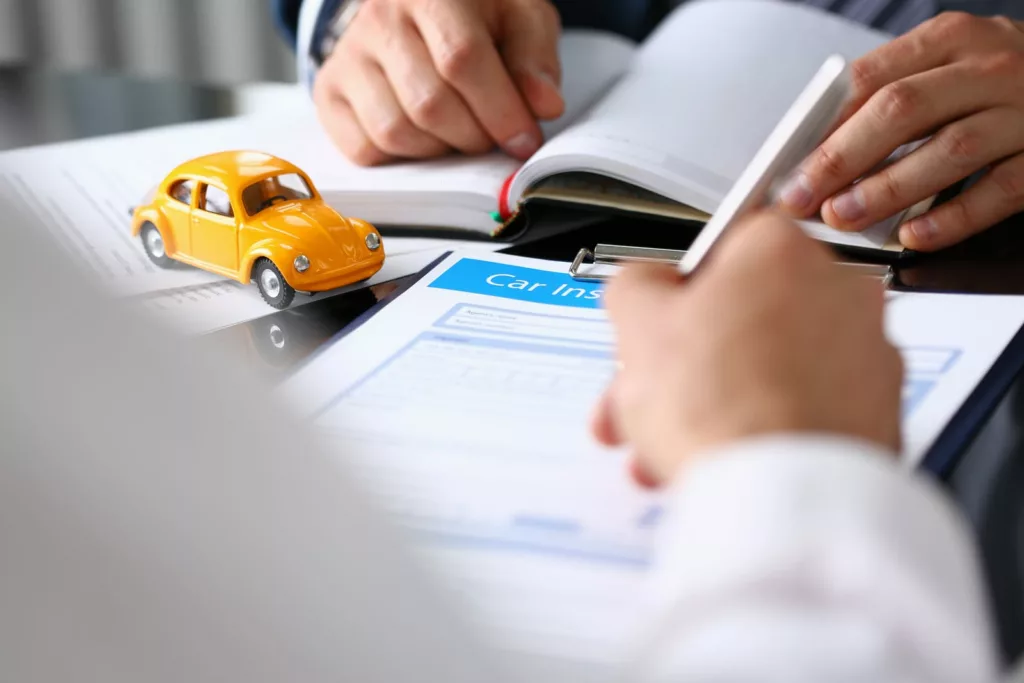 Customer signing a car insurance document