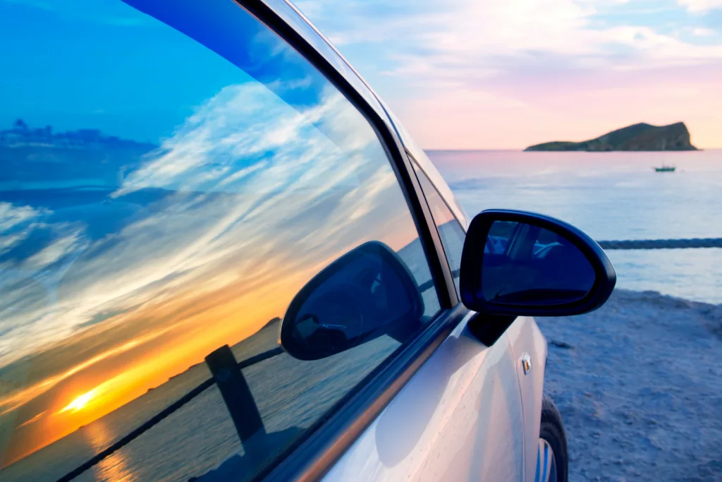 Ibiza cala Conta Conmte susnset reflection y car window glass