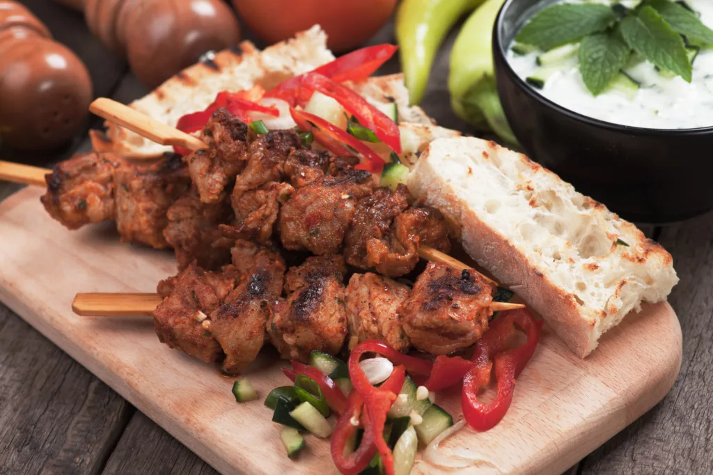 Souvlaki or kebab, meat skewer with toasted bread and fresh vegetable