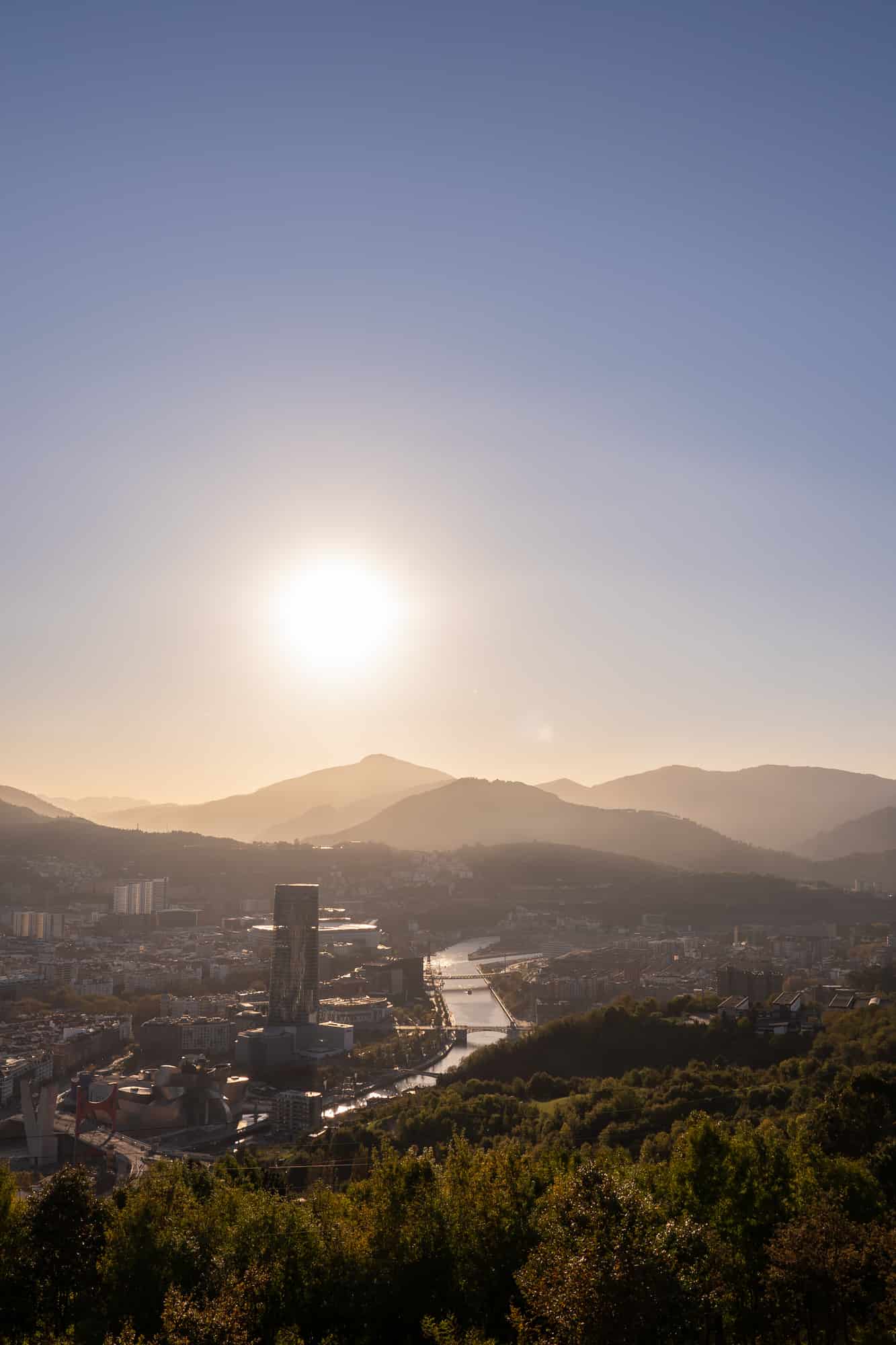 A vertical aerial view of the city of Bilbao in the Basque Country at sunset
