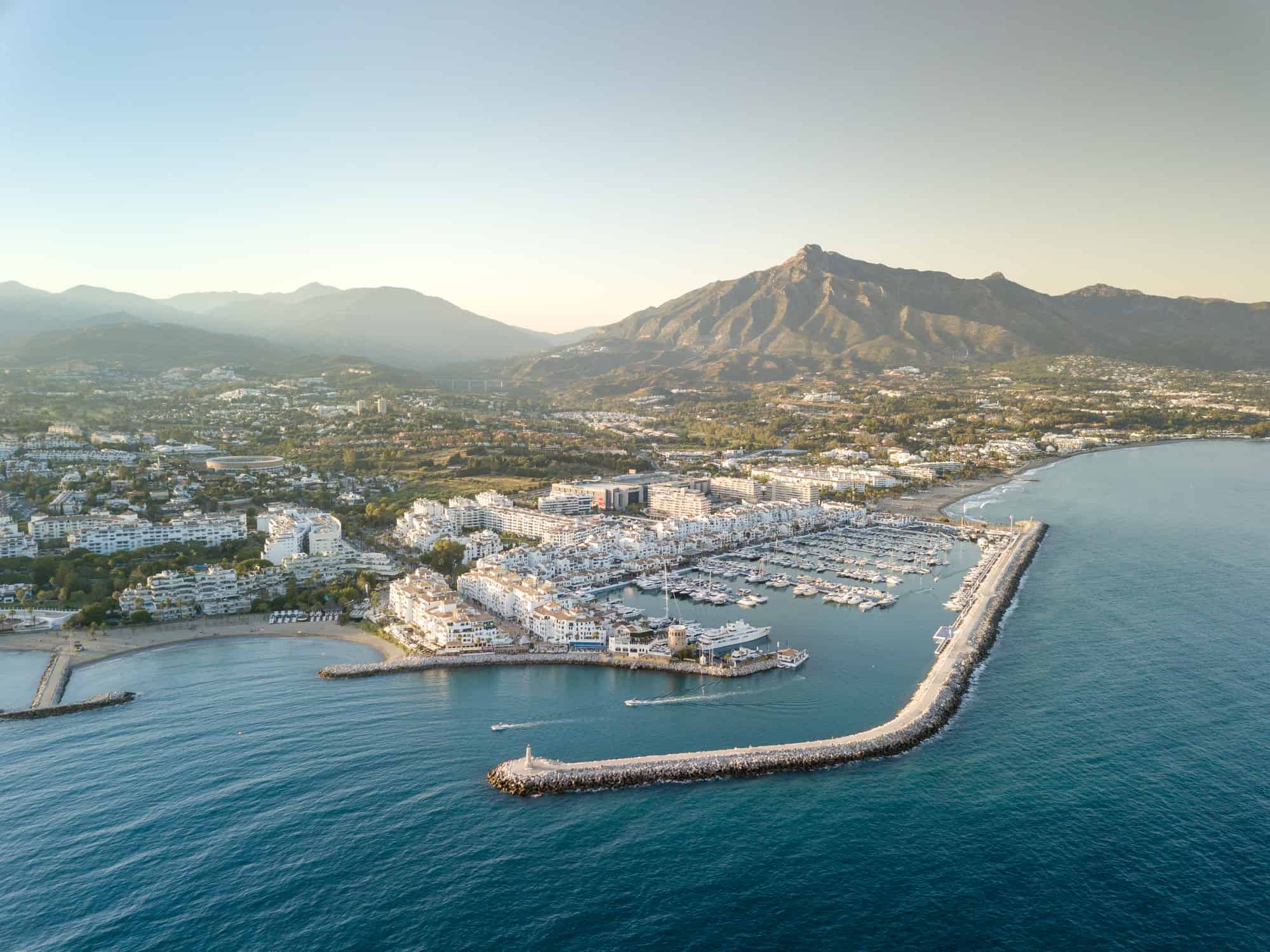 Aerial drone perspective of beautiful sunset over luxury Puerto Banus Bay in Marbella, Costa del Sol