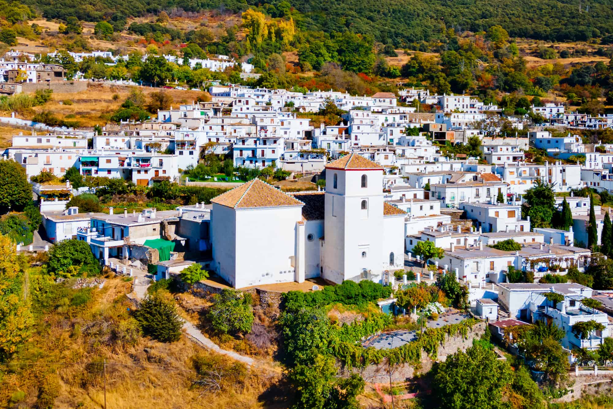 Our Lady of the Rosary Church aerial panoramic view in Bubion. Bubion is a village in the Alpujarras area in the province of Granada in Andalusia, Spain