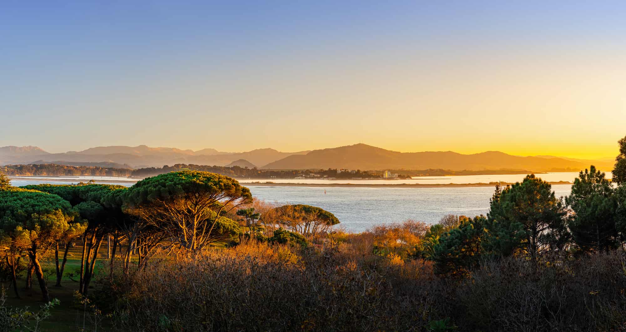 Stunning panoramic views of the fantastic evening light in Santander Bay. View from the Magdalena Peninsula to the Cantabrian Mountains. Santander, Cantabria, Spain