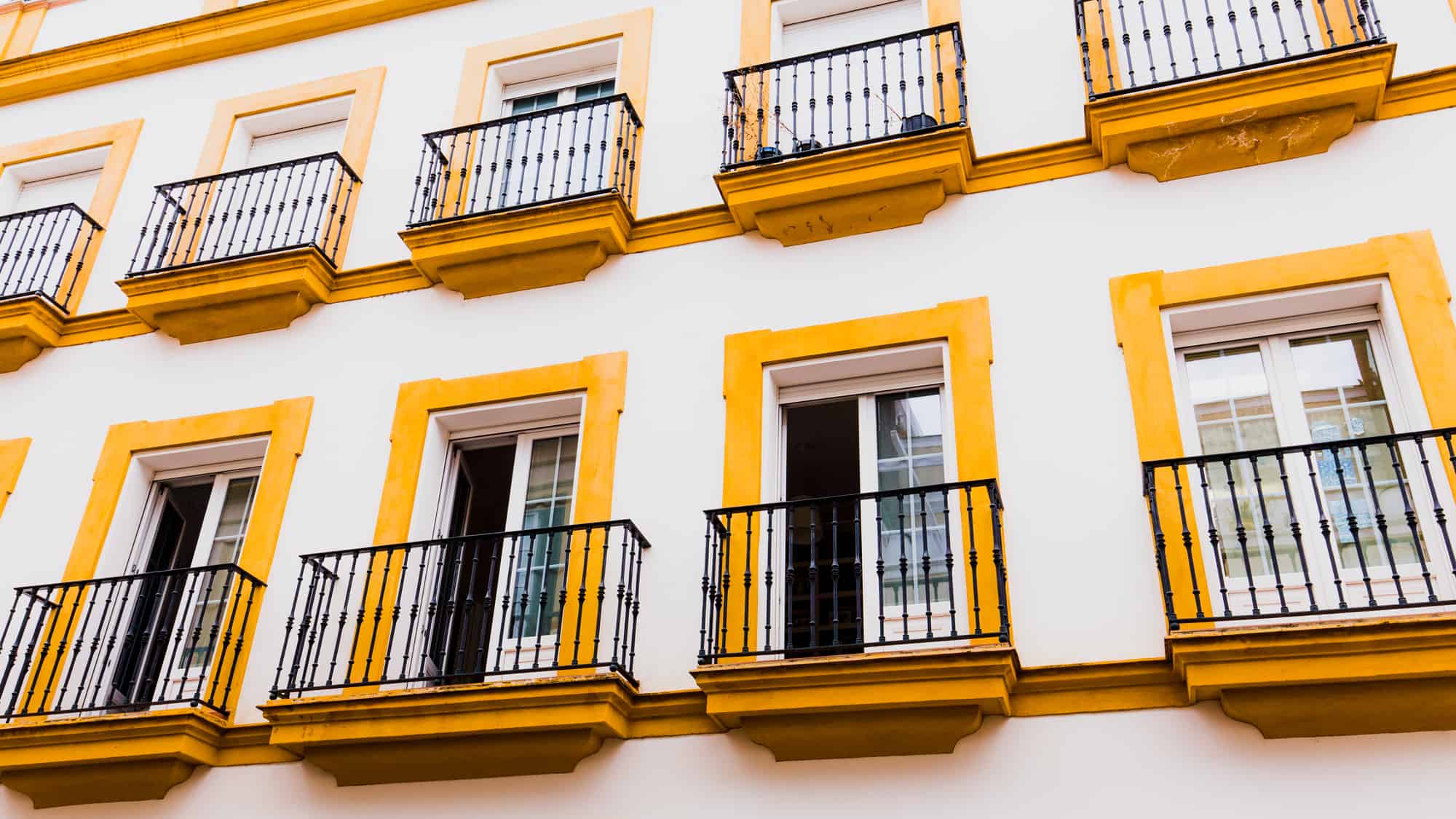 Traditional yellow and white colors of the architecture of Barrio Santa Cruz in Seville