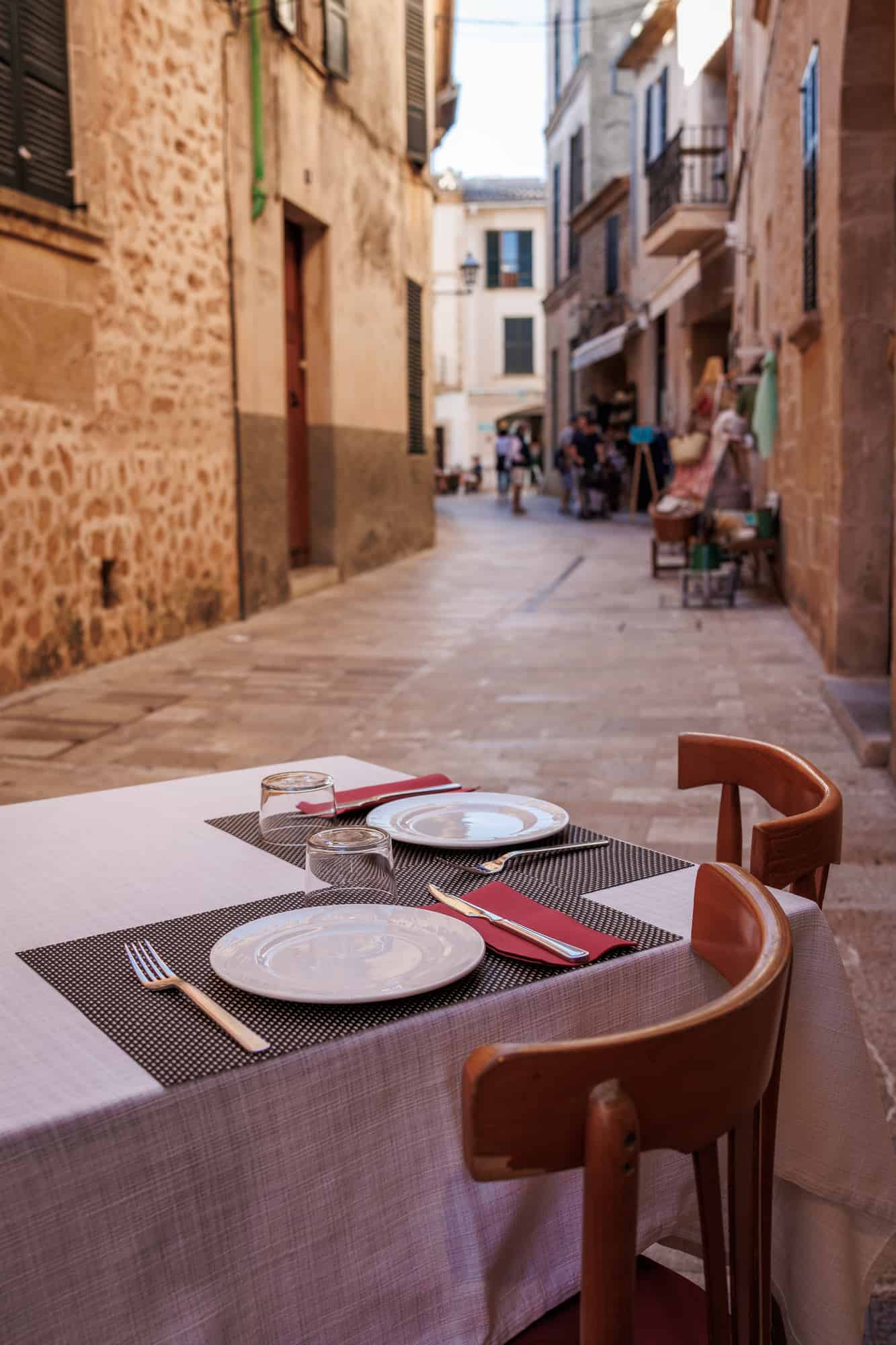 Set table of restaurant on the street in Alcudia, Mallorca