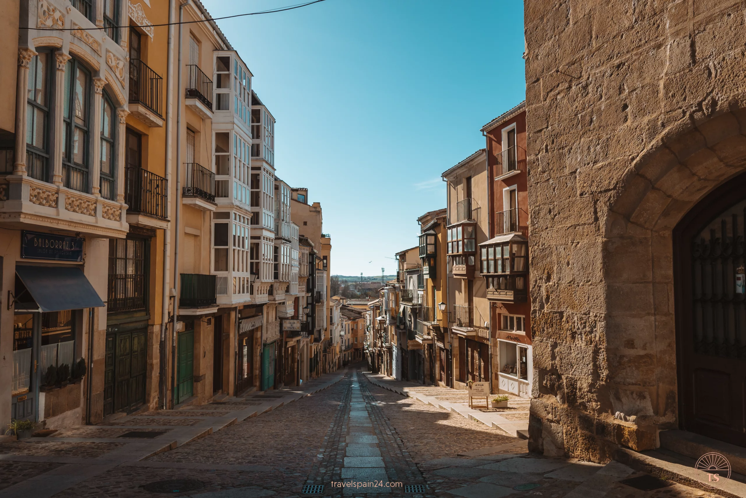 Deserted Calle de Balborraz in Zamora under a clear sunny sky, capturing the peaceful and picturesque essence of the city's historic streets early in the morning, inviting exploration and discovery