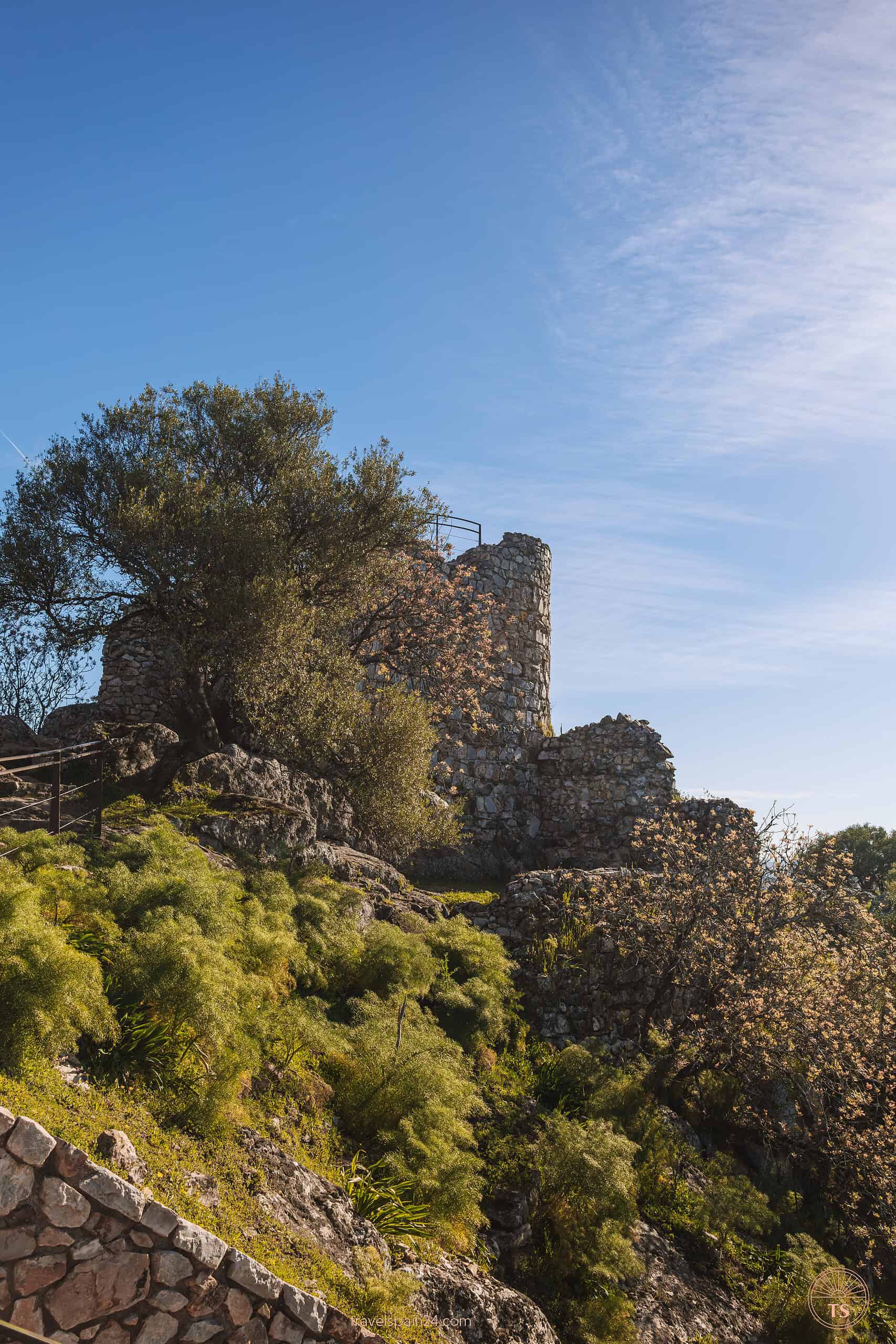 Ruins of the ancient castle atop a hill in Monfragüe National Park, providing expansive views over the landscape.