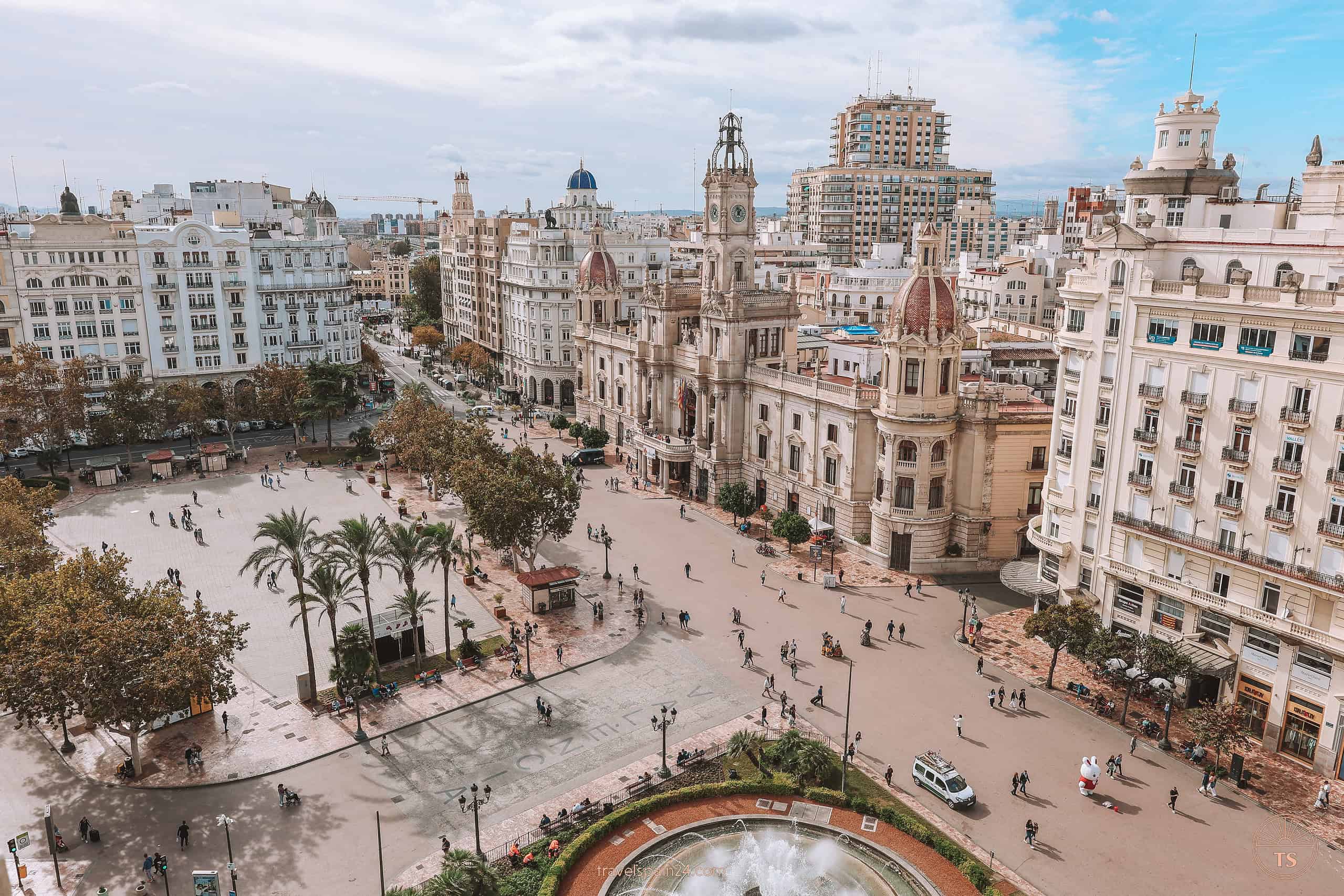 Panoramic view from Atenea Sky Rooftop over Plaza del Ayuntamiento, showcasing the bustling square, its iconic fountain, and the crowd below