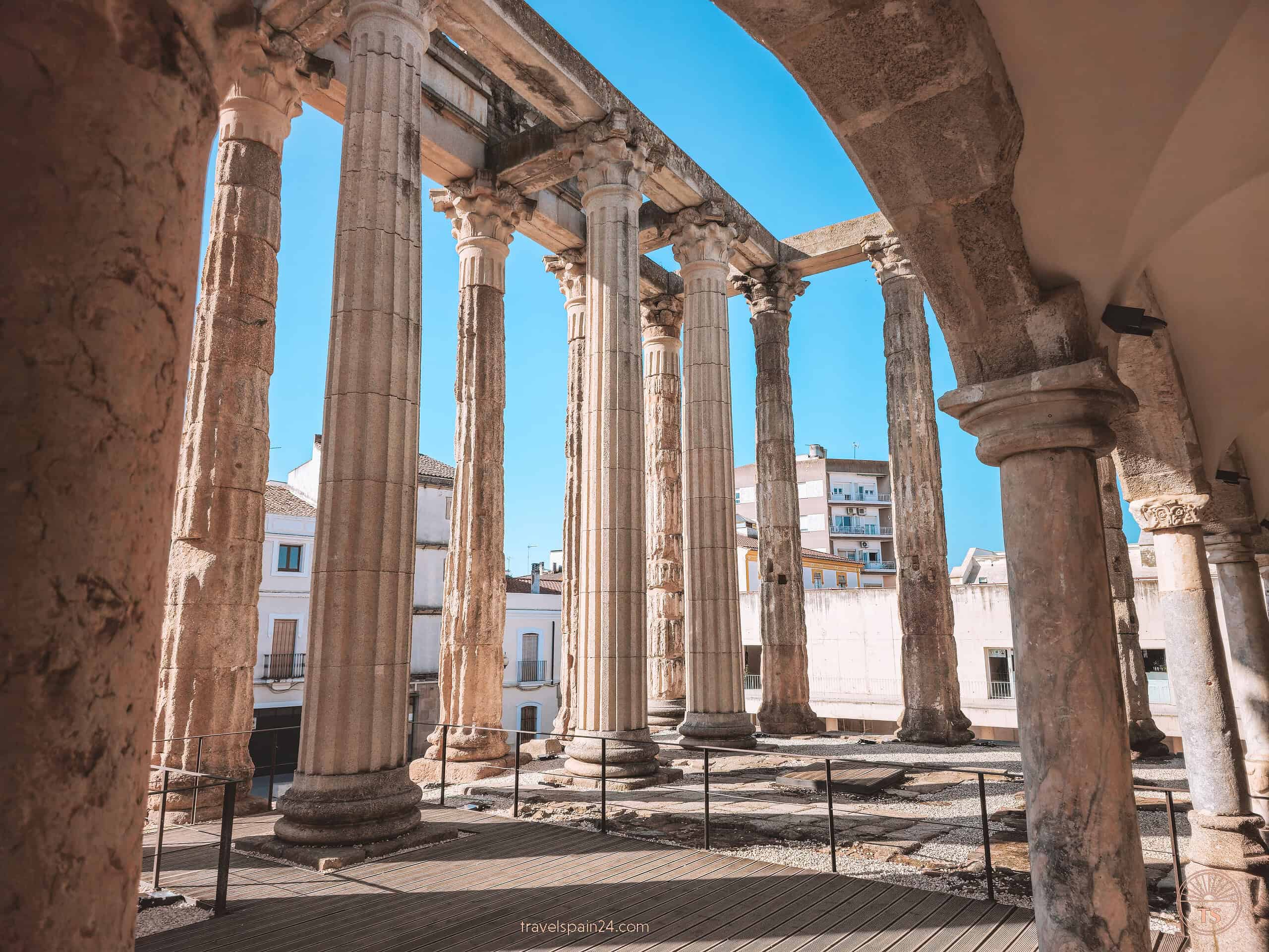 The imposing pillars of the Temple of Diana in Mérida, towering over five meters high under a sunny blue sky, reflecting the city's rich Roman heritage.