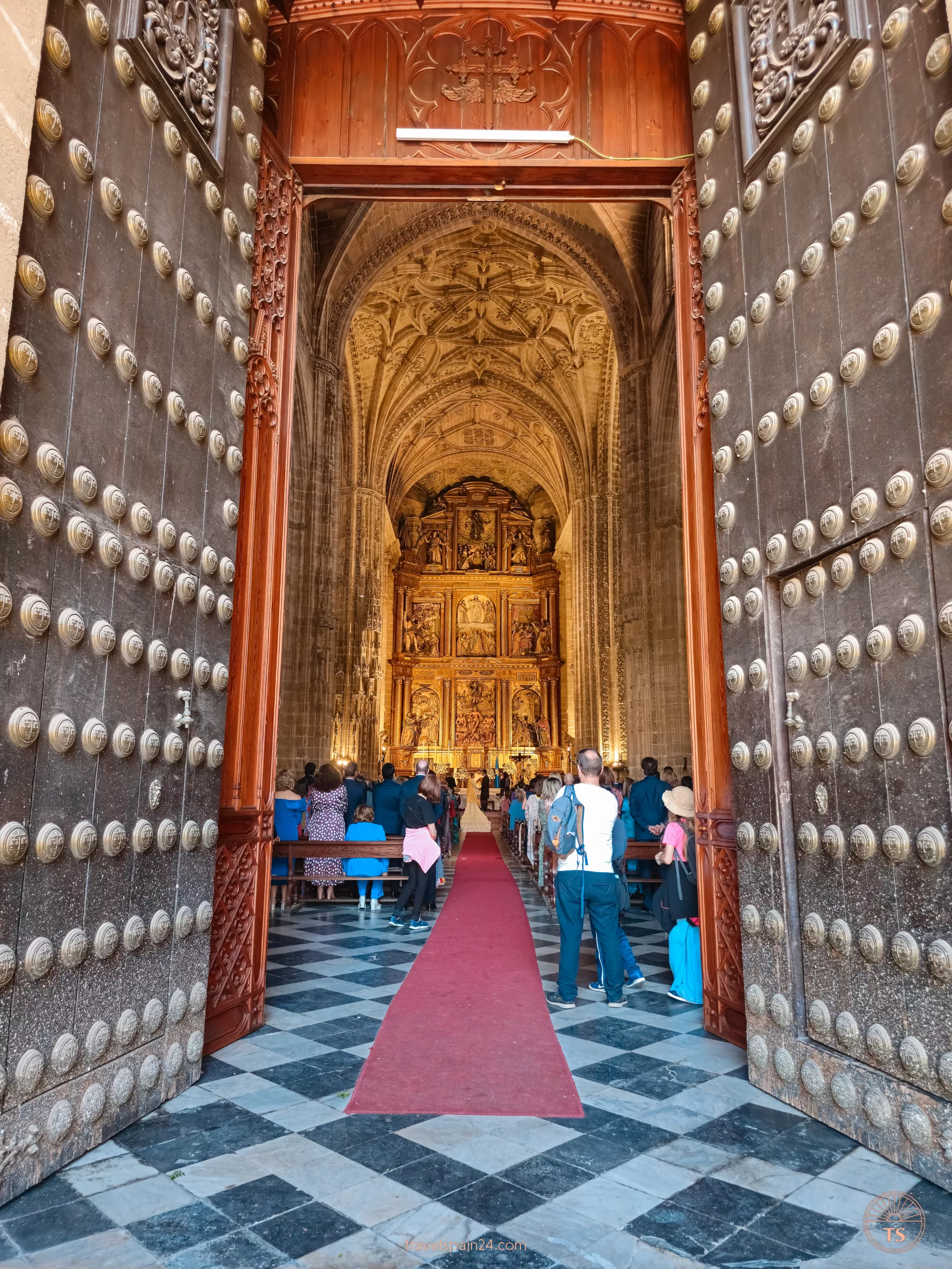 The inside of Iglesia de San Miguel in Jerez de la Frontera during a wedding ceremony. This highlights the cultural and historical significance of the church as a vibrant community center.