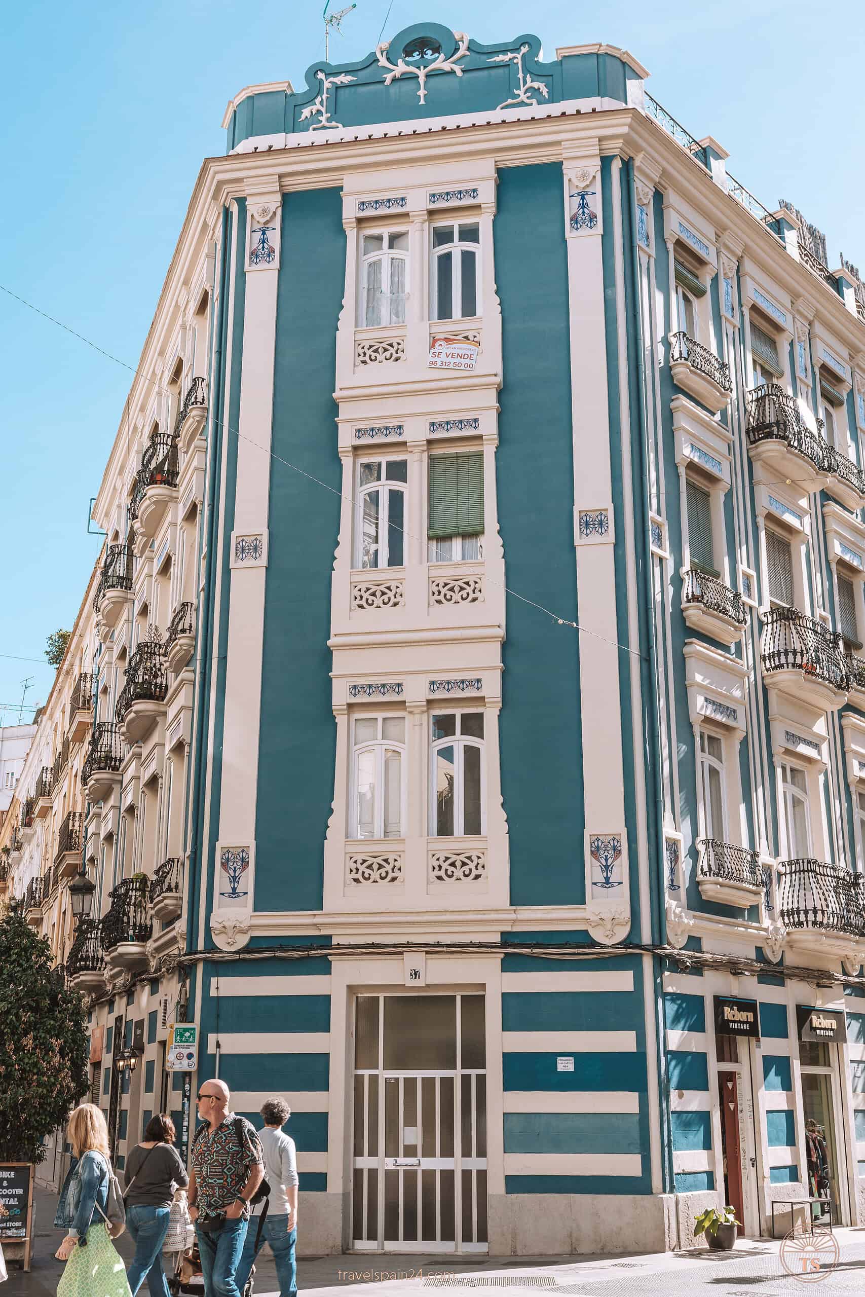 A beautiful blue building with white balconies in the Russafa district of Valencia, displaying the vibrant and colorful architecture that makes the area a must-visit.