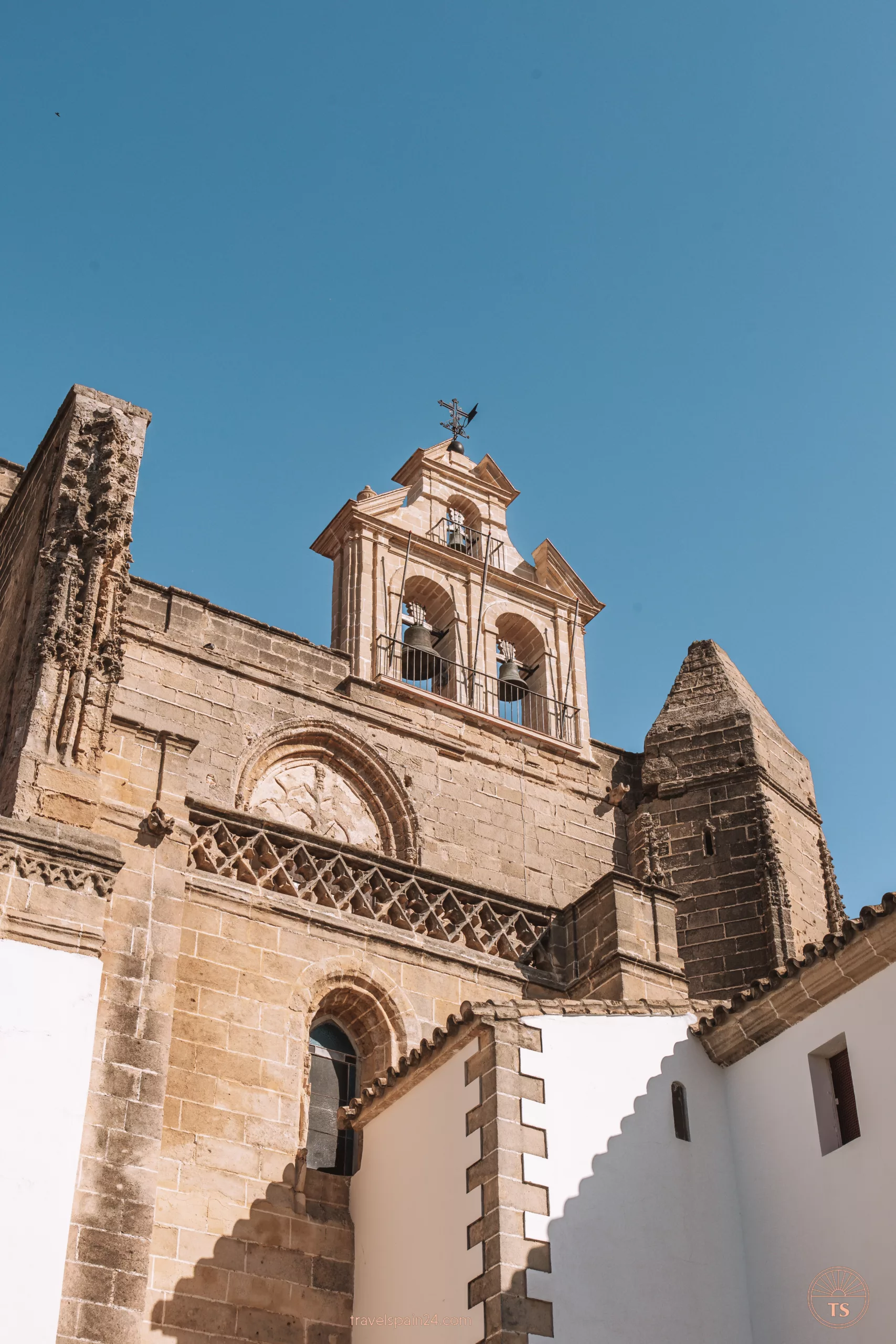 Close-up of the bells at Iglesia de San Mateo in Jerez de la Frontera, highlighting the architectural details. This image relates to the post by showcasing a significant historical and religious site in Jerez de la Frontera.