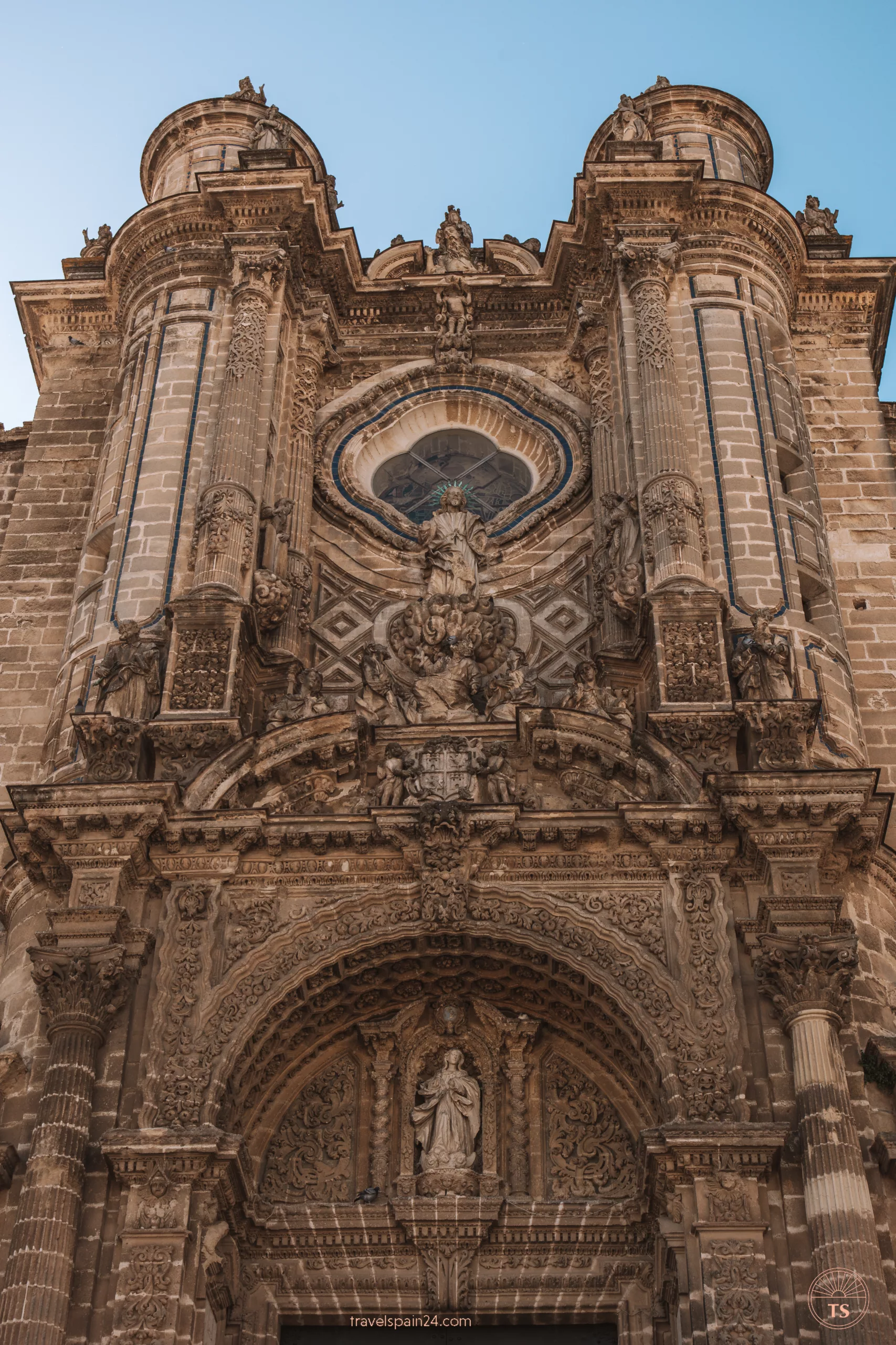 Close-up of the detailed facade of Jerez de la Frontera Cathedral on a sunny day, highlighting the intricate architectural features. This image relates to the post by showcasing one of the city's main attractions.