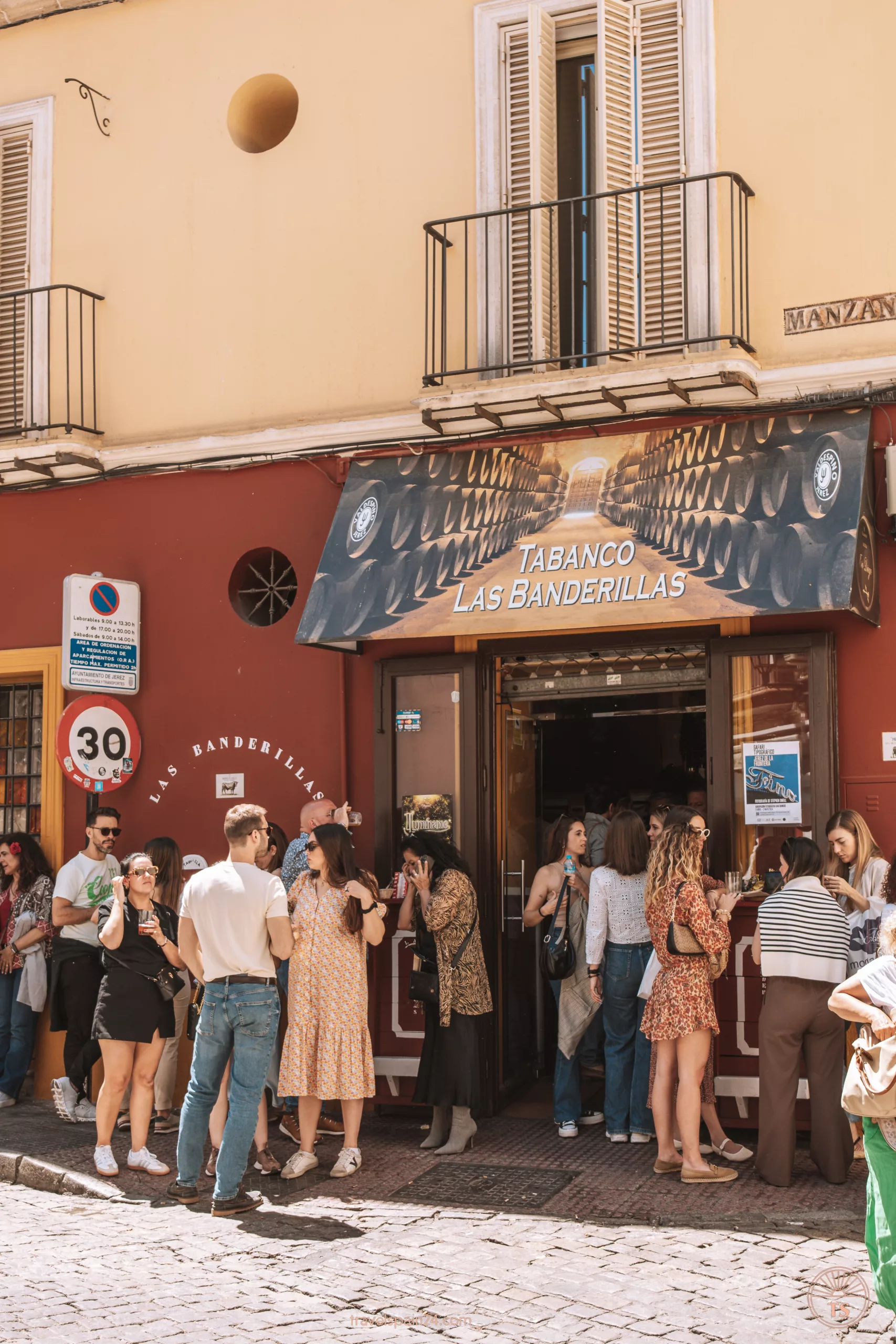 Entrance to Las Banderillas in Jerez de la Frontera, with patrons enjoying food and drinks outdoors. This image relates to the post by featuring a well-loved restaurant in Jerez de la Frontera.