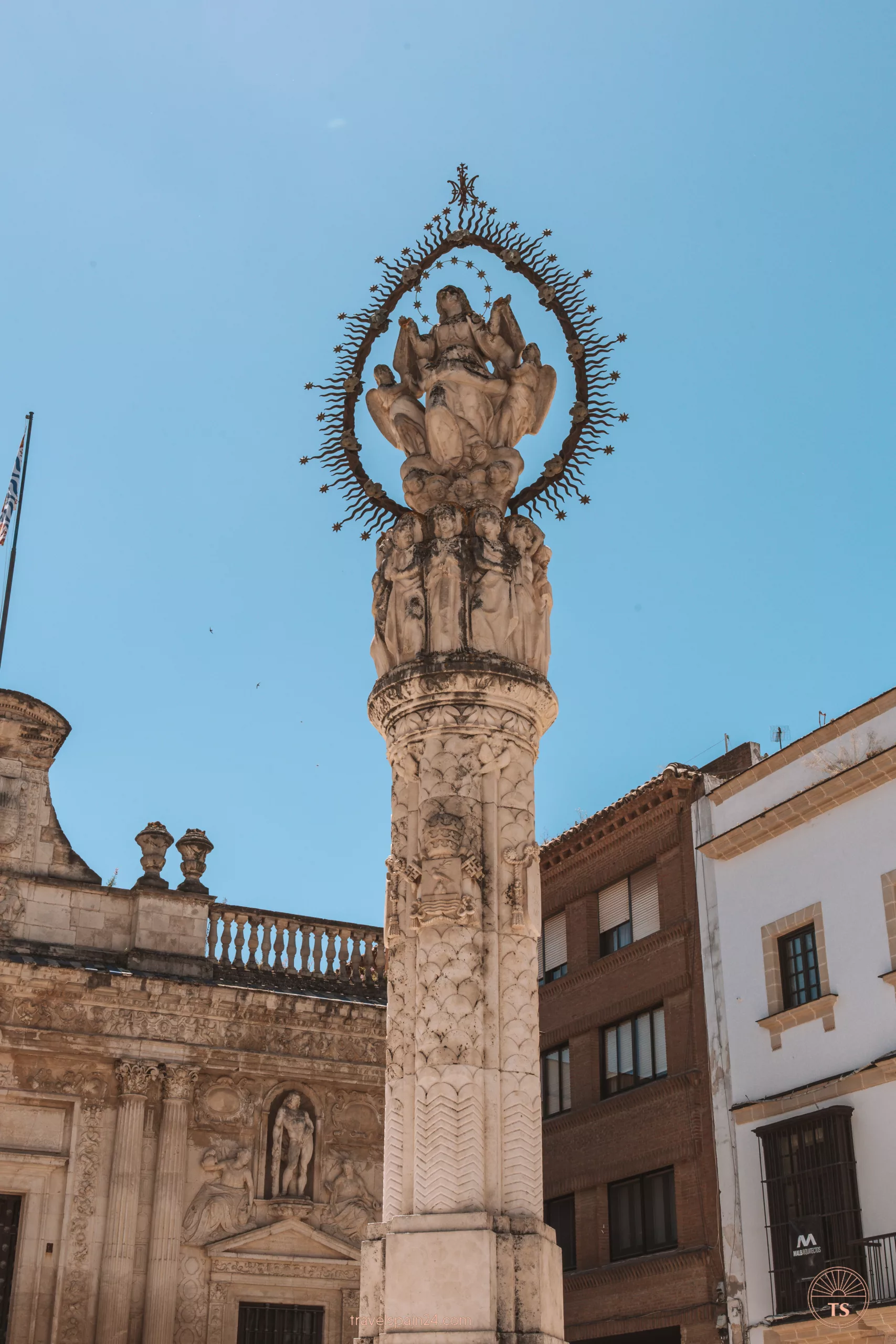 Close-up of the Monumento a la Virgen de la Asunción in Jerez de la Frontera, with the Palacio de la Condesa de Casares in the background. This image highlights a key monument in the city's Plaza de la Asunción.