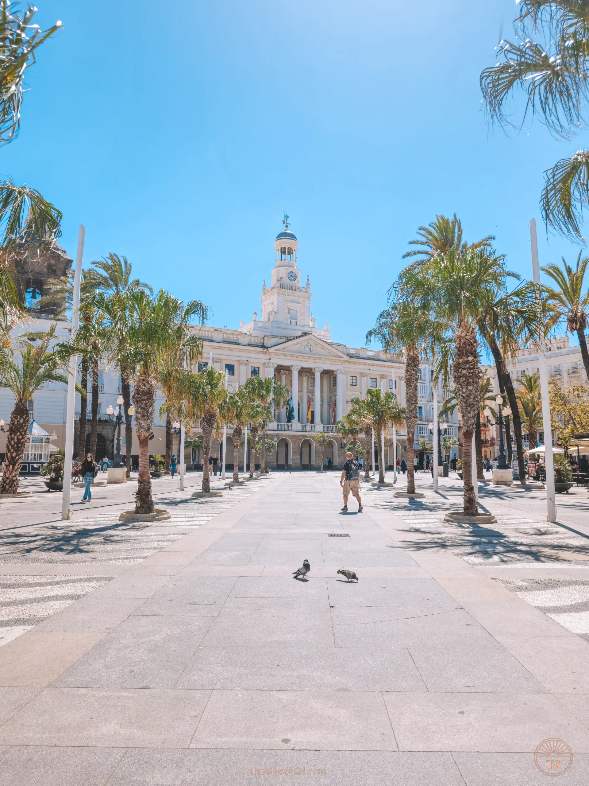 View of Plaza San Juan de Dios on a sunny day, with Cadiz City Hall towering in the background. This image captures the vibrant atmosphere of one of Cadiz's historic squares