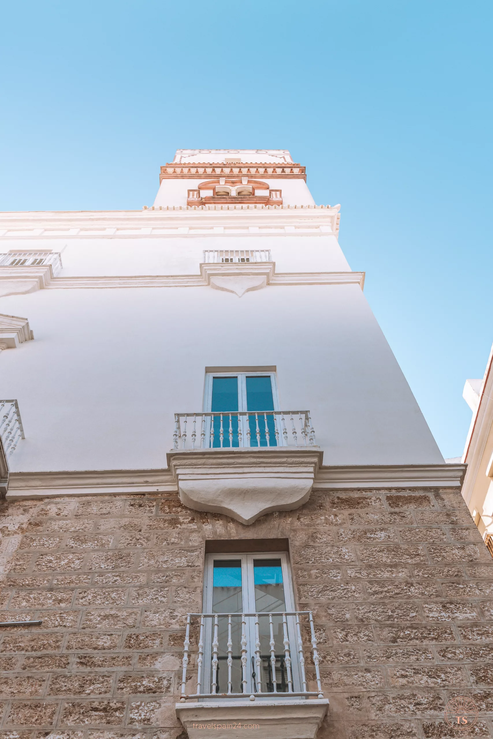 Torre de Tavira from the street in Cadiz, highlighting its prominent structure. This tower is one of the Cadiz highlights, offering historical significance and panoramic views of the city.

