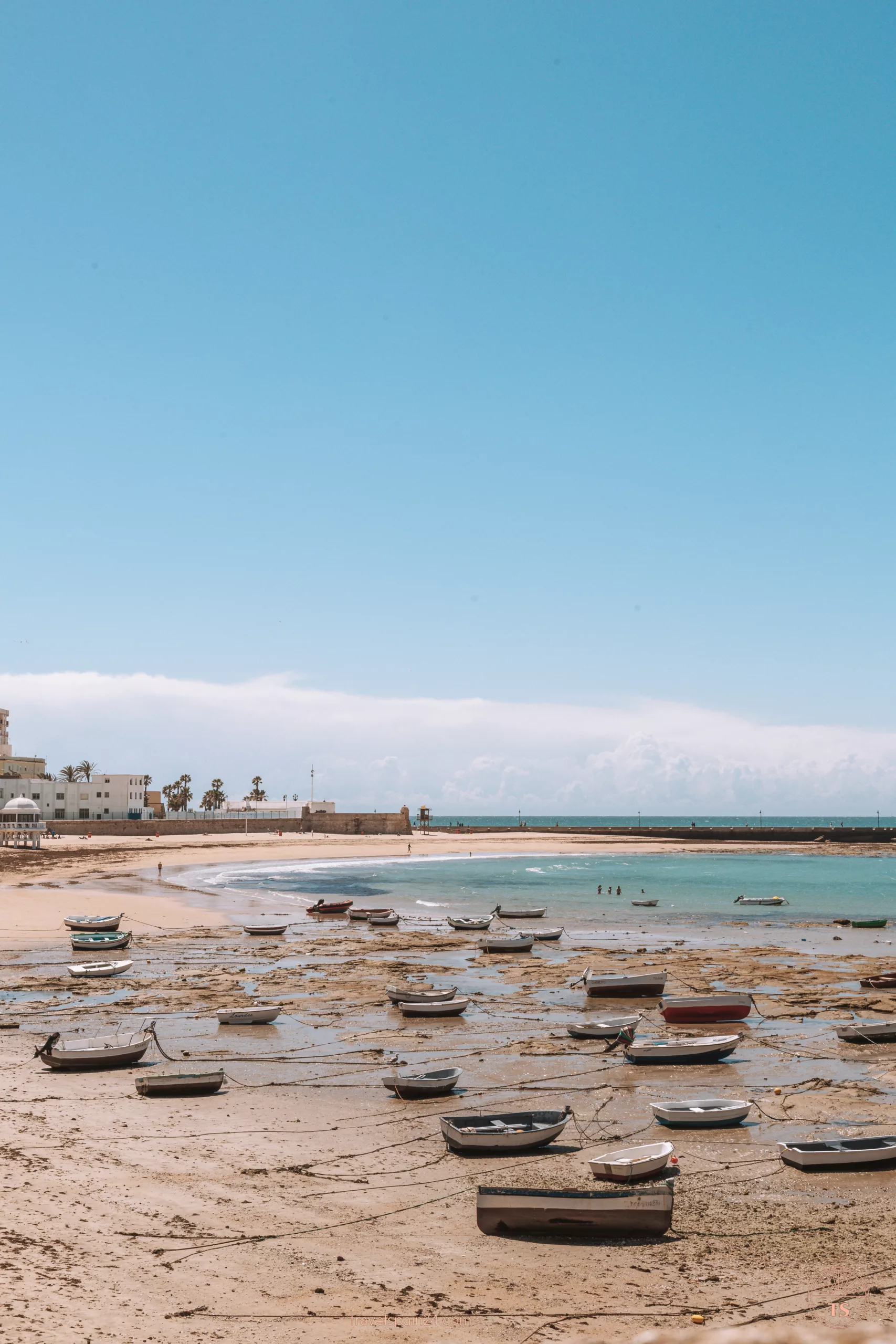 Caleta Beach in Cadiz with boats resting on the sand. This beach is one of the Cadiz highlights, showcasing the picturesque coastal scenery and vibrant maritime culture.
